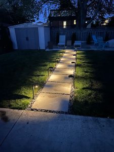 Lumen Landscaping | Interlock Slab walkway with path lights at night