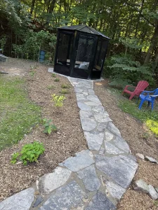 Lumen Landscaping | Gardening Flagstone path through a woodland garden to a screened gazebo