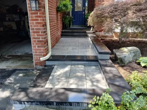 Front entrance walkway steps slab border Front entrance walkway and steps in large slabs with a contrasting border and garden