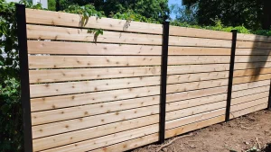 Lumen Landscaping | Leaning Fence or Rotted Posts Horizontal cedar board fence with black posts