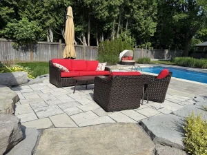 Lumen Landscaping | Interlock Pool patio in large slabs with natural stone accents and garden beds